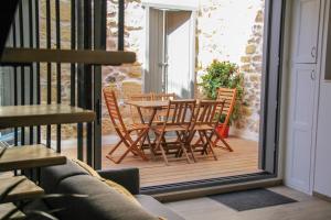 a patio with a table and chairs on a balcony at La Charmeraie in Marseillan