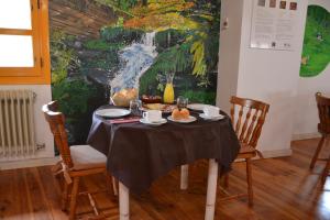 a table with food on it in a room with a painting at Posada Hoyos de Iregua in Villoslada de Cameros
