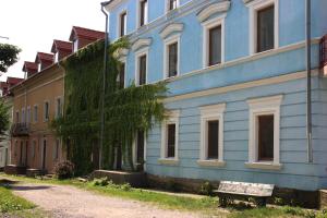 a blue building with a bench in front of it at HISTORICAL OLD CITY Apartament, Старе місто , 2 спальні, балкон-тераса, 85 кв м in Kamianets-Podilskyi