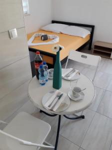 a white table with a vase on it in a room at Studio Apartment Sanja 4 in Neum