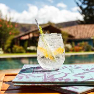 a glass of water with oranges in it on a table at Sol y Luna - Relais & Chateaux in Urubamba