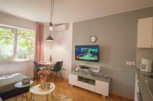 a living room with a flat screen tv on a wall at "Andrija" apartmen's in Banjole