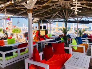 a restaurant with colorful chairs and tables on the beach at Happy Apartments Mamaia Nord 2 Camere in Mamaia Sat/Năvodari