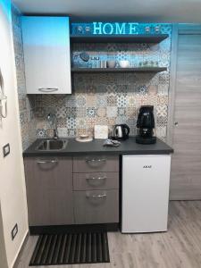 a kitchen with a sink and a counter top at LA CASA DI NANA' in Naples