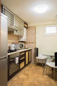 a kitchen with a stainless steel refrigerator and a table at Apartment for Rent on Deribasovskaya street in Odesa