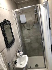 a bathroom with a shower and a sink at The Bold St LiverPods by Serviced Living Liverpool in Liverpool