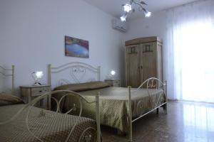 Postel nebo postele na pokoji v ubytování Don Nicola Residence