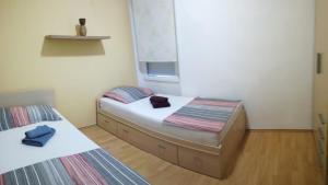 コペルにあるApartment Možinaのベッド2台と窓が備わる小さな客室です。