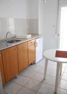 a kitchen with a sink and a table at Lemonia in Paralia Katerinis