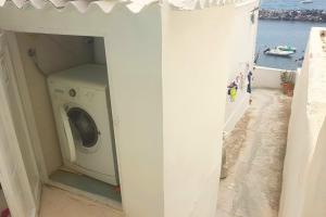 a washing machine in a room with a view of the ocean at Casa Gastronomo in Procida