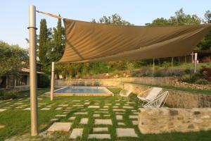 a canopy over a pool in a yard at Domaine de Fonteyrol in Rochefort-en-Valdaine