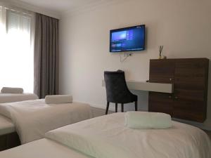 Postel nebo postele na pokoji v ubytování Hotel Dardani