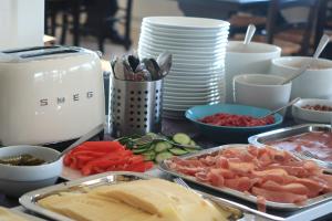 a table topped with trays of different types of food at Magic Mountain Lodge - Lyngen in Lyngseidet