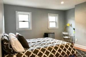 a bedroom with a bed and two windows at Clean Comfy Centrally Located Private Room in Boston