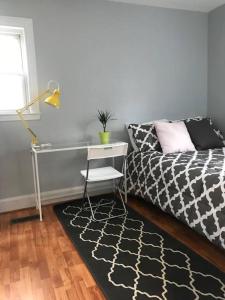 a bedroom with a desk and a bed and a table at Clean Comfy Centrally Located Private Room in Boston