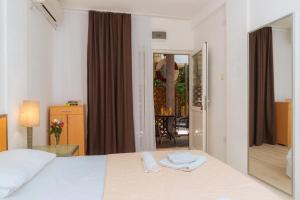 a bedroom with a bed with two towels on it at Hotel Savojo in Petrovac na Moru