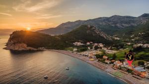 an aerial view of a beach at sunset at Hotel Savojo in Petrovac na Moru