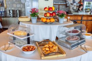 a table filled with lots of different types of food at Hotel Savojo in Petrovac na Moru