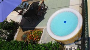 a swimming pool with a toilet in a garden at Apartment Gamma with hydromassage mini pool near Split in Žrnovnica