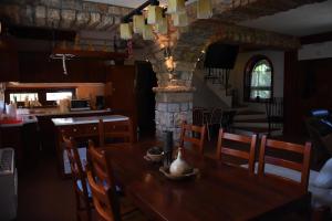 a dining room with a table and a stone pillar at Villa Serz in Bitola