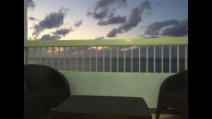 a view of the ocean from a balcony with a chair at Al-Madina Tower Apartments in Marsa Matruh