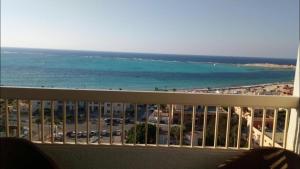 a balcony with a view of the beach and the ocean at Al-Madina Tower Apartments in Marsa Matruh +37 photos