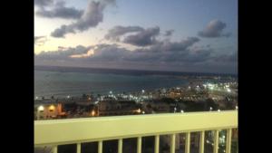 a view of the ocean from a balcony of a building at Al-Madina Tower Apartments in Marsa Matruh