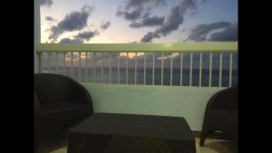 a balcony with two chairs and a view of the ocean at Al-Madina Tower Apartments in Marsa Matruh