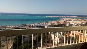 a view of the ocean from a balcony of a building at Al-Madina Tower Apartments in Marsa Matruh