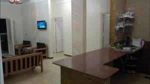 a living room with a kitchen with a counter top at Al-Madina Tower Apartments in Marsa Matruh