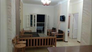 a living room with a couch and a table and chairs at Al-Madina Tower Apartments in Marsa Matruh