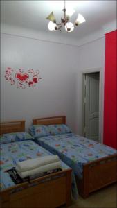 a bedroom with a bed and a ceiling fan at Al-Madina Tower Apartments in Marsa Matruh