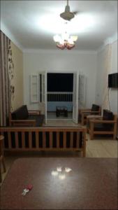 a living room with a couch and a television at Al-Madina Tower Apartments in Marsa Matruh