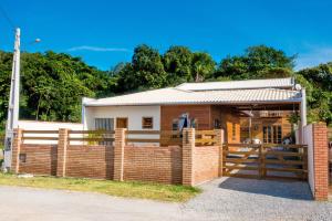 una casa de ladrillo con una valla delante de ella en Sobrados da Sinhá, en Penha