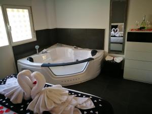 a bathroom with a tub and two swans towels at Gredos Loft in Arenas de San Pedro