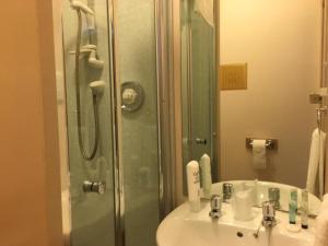 a bathroom with a sink and a shower at Terra Nova Hotel in Aberdeen