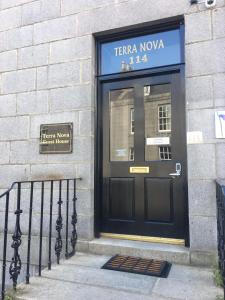 a black door on the side of a building at Terra Nova Hotel in Aberdeen