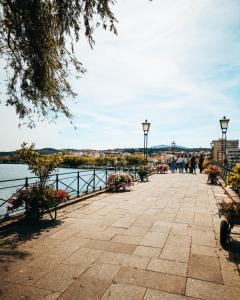 a walkway next to a body of water at Casa da Ponte in Mirandela