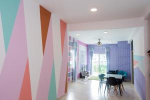 a dining room with colorful walls and a table at ICOLOR HOME & STAY CH1 in Tanah Rata