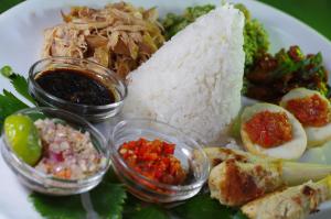 a plate of food with rice and other foods at Bali Eco Village in Plaga