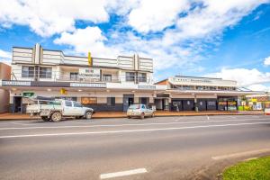 a building with cars parked in front of a street at Nightcap at Atherton Hotel in Atherton