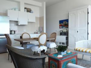 a kitchen with a table and chairs and a table and a kitchen at La Dolce Vita in Lagoa