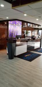 an office with a vase of purple flowers in a lobby at Baymont by Wyndham Montreal Airport in Dorval