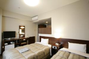 Postel nebo postele na pokoji v ubytování Hotel Route-Inn Kanda Ekimae