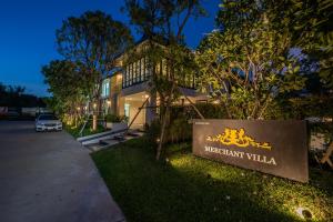 a sign for the meridian villa at night at Merchant Villa- SHA Extra Plus in Chiang Mai