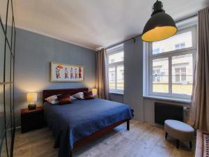 a bedroom with a bed and a large window at Ruska61 Apart in Wrocław