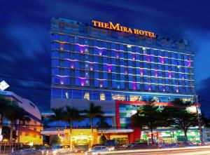 a hotel building with a sign on top of it at The Mira Hotel in Thu Dau Mot