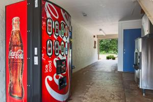 a coca cola vending machine in a room at Motel 6-Atlanta, TX in Atlanta
