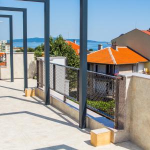 a balcony with poles and a view of a house at VIDA in Lozenets