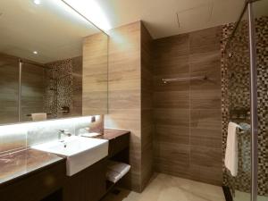 a bathroom with a sink and a shower at Lai Hotel in Guiren